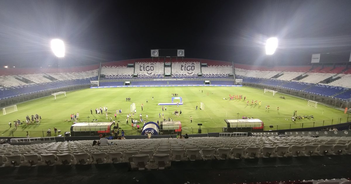 El estadio Defensores del Chaco iluminado de noche, con las tribunas vacías, en el barrio Sajonia de Asunción