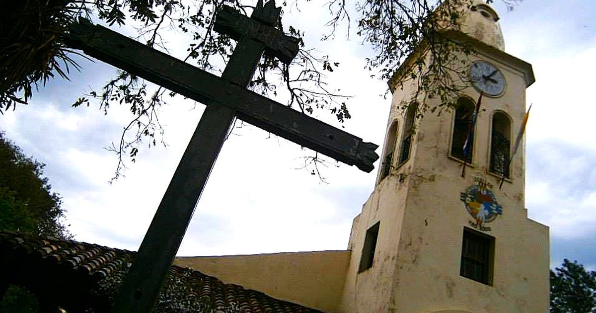 Cruz de madera y torre del Santuario Ñandejára Guasu de Piribebuy, en Cordillera